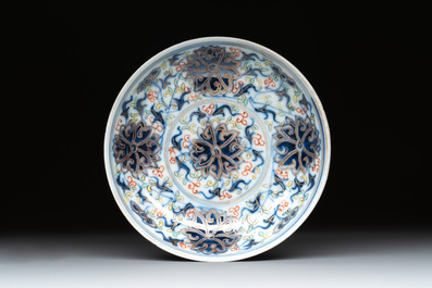 A Chinese gilt-decorated blue and white 'lotus scroll' square bowl, a saucer and a doucai 'dragon' cup, Daoguang mark and of the period