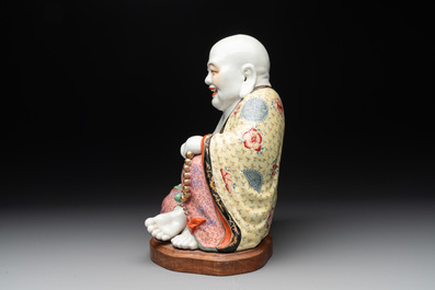A large Chinese famille rose Milefo Buddha on wooden stand, 20th C.