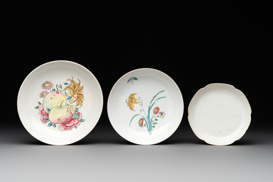 Three Chinese ruby-ground famille rose plates and a cup, 19th C.
