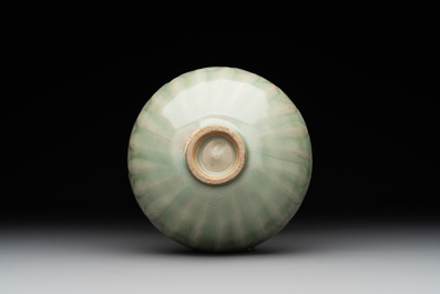 A Chinese Longquan celadon 'lotus' bowl and a large green-glazed jar, Ming and later