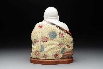 A large Chinese famille rose Milefo Buddha on wooden stand, 20th C.