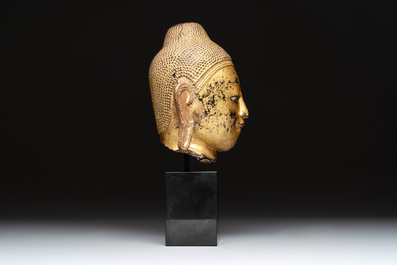 A Burmese gilt-lacquered bronze head of Buddha, 19th C.