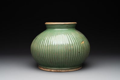 A Chinese Longquan celadon 'lotus' bowl and a large green-glazed jar, Ming and later