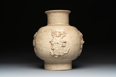 A Chinese sancai figure of Garuda, a cream-glazed vase and a pair of wucai jars, 19th C.