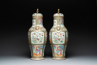 A pair of Chinese Canton famille rose vases and covers with narrative design, 19th C.