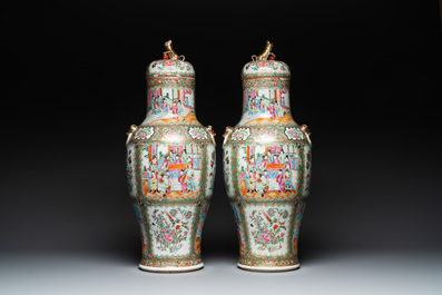 A pair of Chinese Canton famille rose vases and covers with narrative design, 19th C.