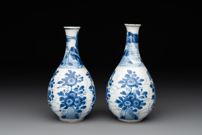 A pair of Chinese blue and white pear-shaped vases with cranes among flowering branches, Kangxi