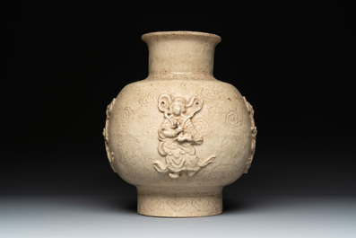 A Chinese sancai figure of Garuda, a cream-glazed vase and a pair of wucai jars, 19th C.