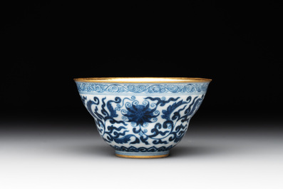A Chinese gilt-decorated blue and white 'lotus scroll' bowl, Daoguang mark and of the period