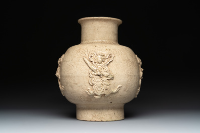 A Chinese sancai figure of Garuda, a cream-glazed vase and a pair of wucai jars, 19th C.