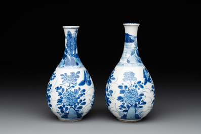 A pair of Chinese blue and white pear-shaped vases with cranes among flowering branches, Kangxi
