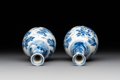 A pair of Chinese blue and white pear-shaped vases with cranes among flowering branches, Kangxi