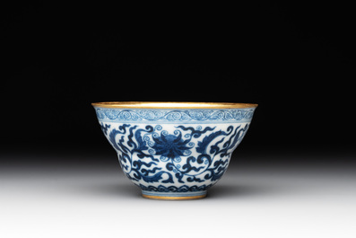 A Chinese gilt-decorated blue and white 'lotus scroll' bowl, Daoguang mark and of the period