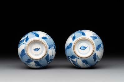 A pair of Chinese blue and white pear-shaped vases with cranes among flowering branches, Kangxi