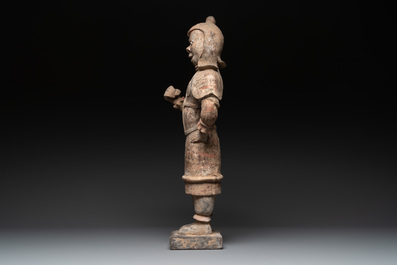 A large Chinese painted pottery figure of a standing guardian, Tang