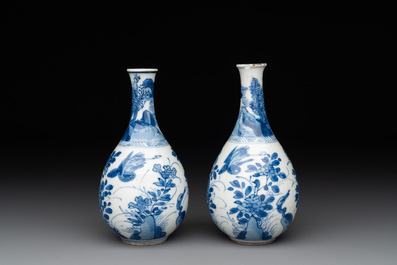 A pair of Chinese blue and white pear-shaped vases with cranes among flowering branches, Kangxi