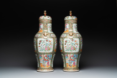 A pair of Chinese Canton famille rose vases and covers with narrative design, 19th C.