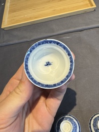 A collection of 32 pieces Chinese blue and white cups, saucers and covers with floral design, Qianlong