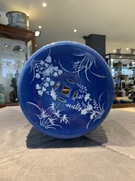 A pair of Chinese white slip-decorated blue-ground garden seats, 19th C.