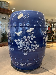 A pair of Chinese white slip-decorated blue-ground garden seats, 19th C.
