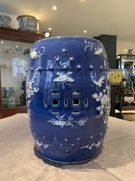 A pair of Chinese white slip-decorated blue-ground garden seats, 19th C.