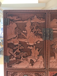 A Chinese cinnabar lacquer 'mountainous landscape' cabinet, 19th C.
