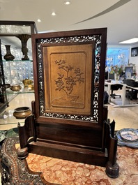 A large Chinese carved wooden table screen with a fine famille rose 'landscape' plaque, 19th C.