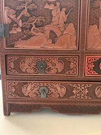 A Chinese cinnabar lacquer 'mountainous landscape' cabinet, 19th C.