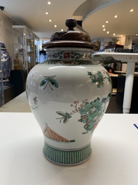 A Chinese famille rose coral-red-ground vase and a famille verte vase, 19th C.