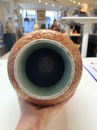 A Chinese famille rose coral-red-ground vase and a famille verte vase, 19th C.