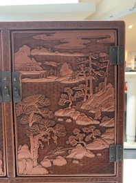 A Chinese cinnabar lacquer 'mountainous landscape' cabinet, 19th C.