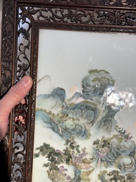 A large Chinese carved wooden table screen with a fine famille rose 'landscape' plaque, 19th C.