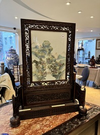 A large Chinese carved wooden table screen with a fine famille rose 'landscape' plaque, 19th C.