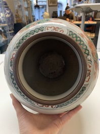 A Chinese famille rose coral-red-ground vase and a famille verte vase, 19th C.