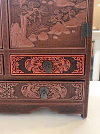A Chinese cinnabar lacquer 'mountainous landscape' cabinet, 19th C.