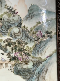 A large Chinese carved wooden table screen with a fine famille rose 'landscape' plaque, 19th C.