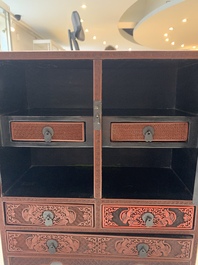 A Chinese cinnabar lacquer 'mountainous landscape' cabinet, 19th C.