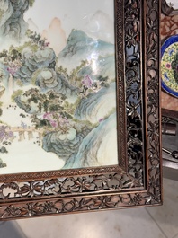 A large Chinese carved wooden table screen with a fine famille rose 'landscape' plaque, 19th C.