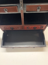 A Chinese cinnabar lacquer 'mountainous landscape' cabinet, 19th C.
