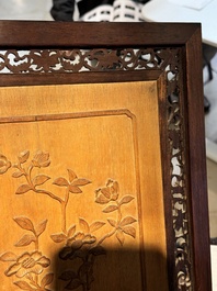 A large Chinese carved wooden table screen with a fine famille rose 'landscape' plaque, 19th C.