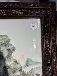 A large Chinese carved wooden table screen with a fine famille rose 'landscape' plaque, 19th C.