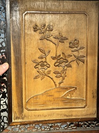 A large Chinese carved wooden table screen with a fine famille rose 'landscape' plaque, 19th C.