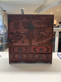 A Chinese cinnabar lacquer 'mountainous landscape' cabinet, 19th C.