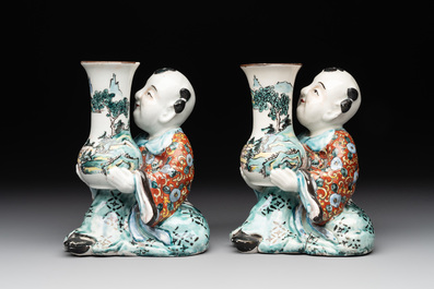 A pair of Japanese polychrome boy-shaped vases, 19th C.