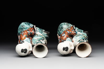 A pair of Japanese polychrome boy-shaped vases, 19th C.