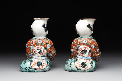 A pair of Japanese polychrome boy-shaped vases, 19th C.