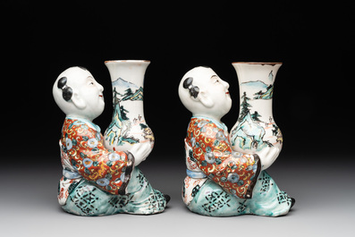 A pair of Japanese polychrome boy-shaped vases, 19th C.