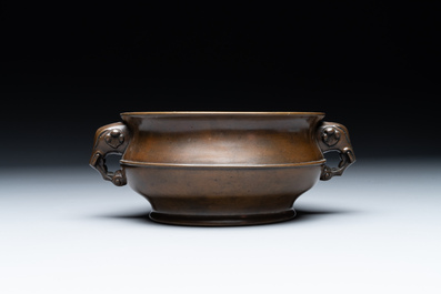 A Chinese bronze elephant-head-handled censer, Wan Shou Wu Jiang 萬壽無疆 mark, 19th C.