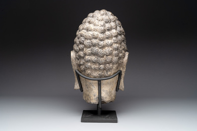 A large Chinese stone head of Buddha with traces of gilding and polychromy, Ming