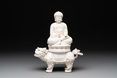 A Chinese Dehua blanc de Chine Buddha seated on a lion, 20th C.
